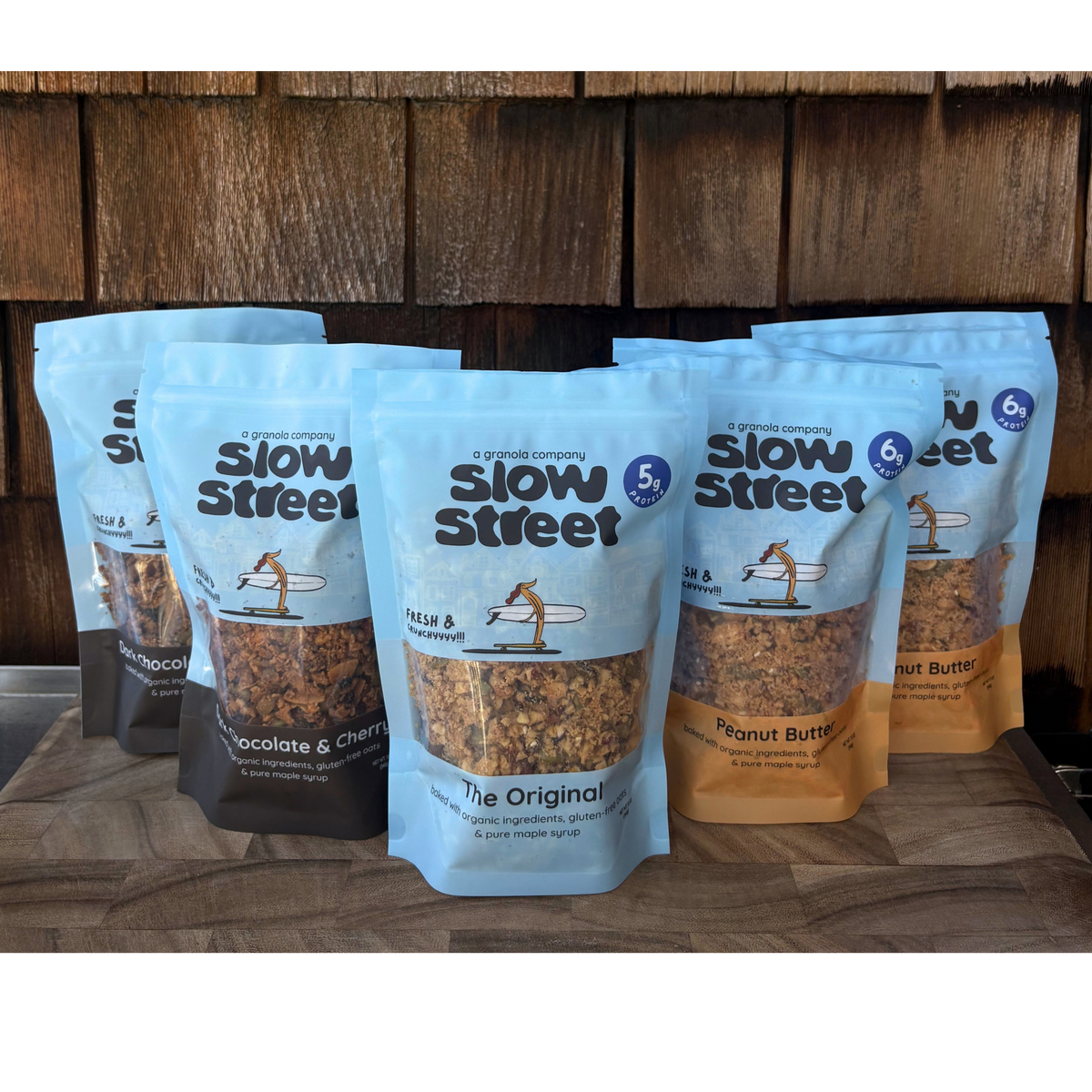 Slow Street five-bag granola bundle: two Dark Chocolate and Cherry, one Original, and two Peanut Butter bags, all facing front.