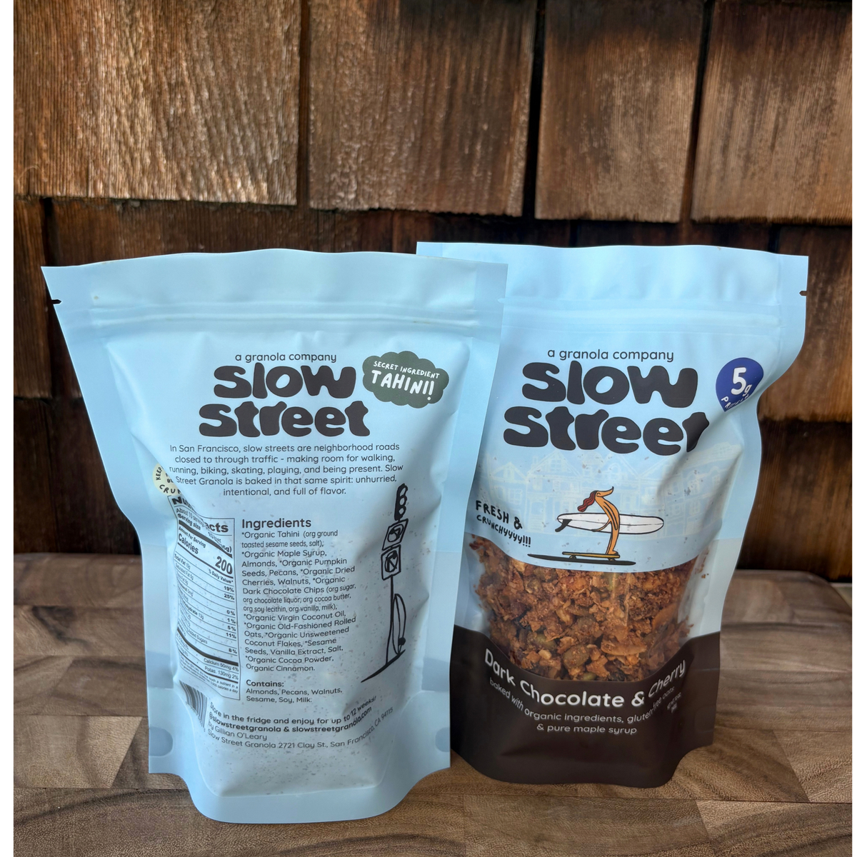 Slow Street Dark Chocolate and Cherry granola, 2 12 oz (340 g) bags, one showing its back.