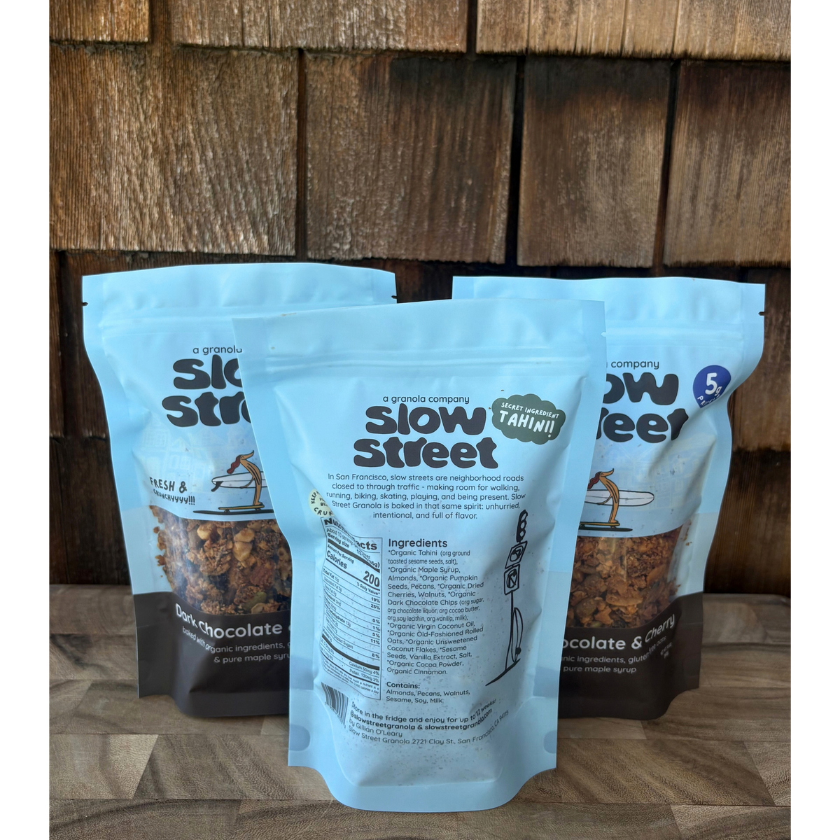 Slow Street Dark Chocolate and Cherry granola, 3 12 oz (340 g) bags, one showing its back.