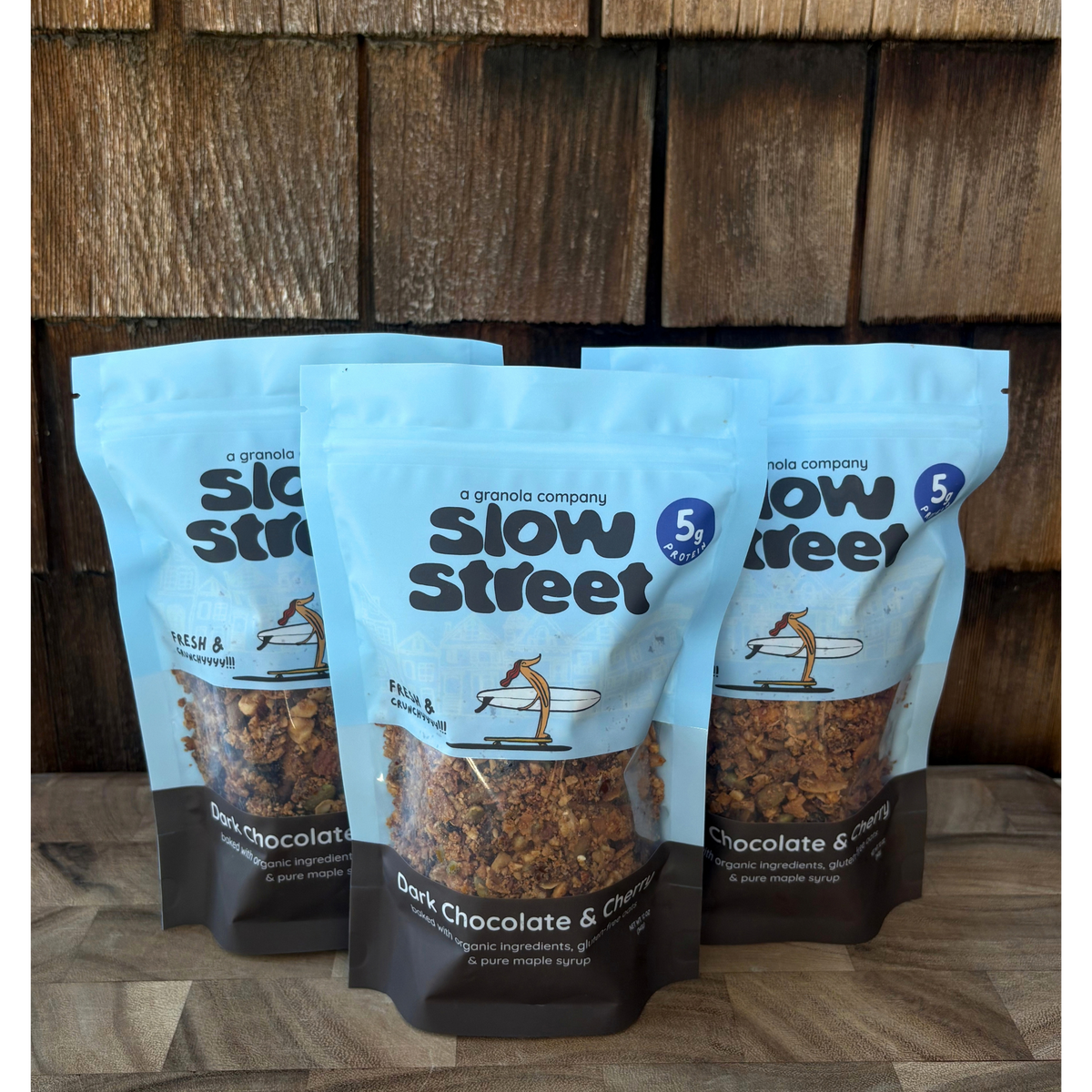 Slow Street Dark Chocolate and Cherry granola, 3 12 oz (340 g) bags, all facing front.
