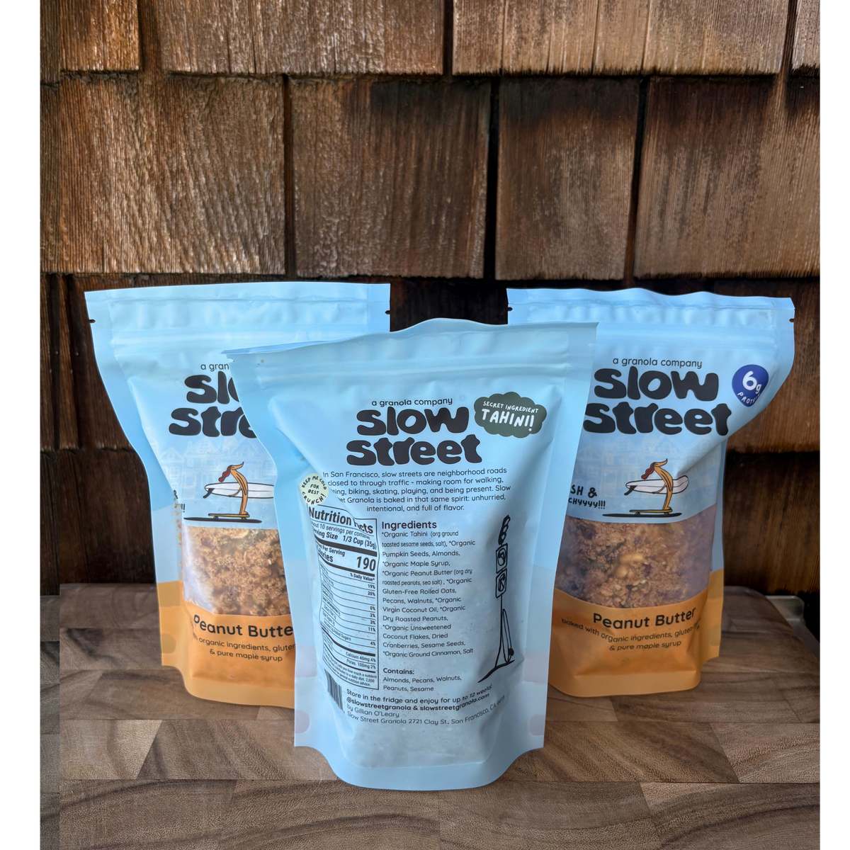 Slow Street peanut butter granola, 3 12 oz (340 g) bags, one showing its back.